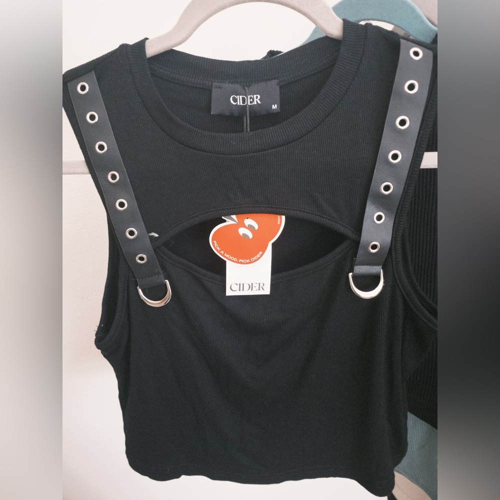 Selling a medium black Cider top that has a cutout in the front w/ belt straps!